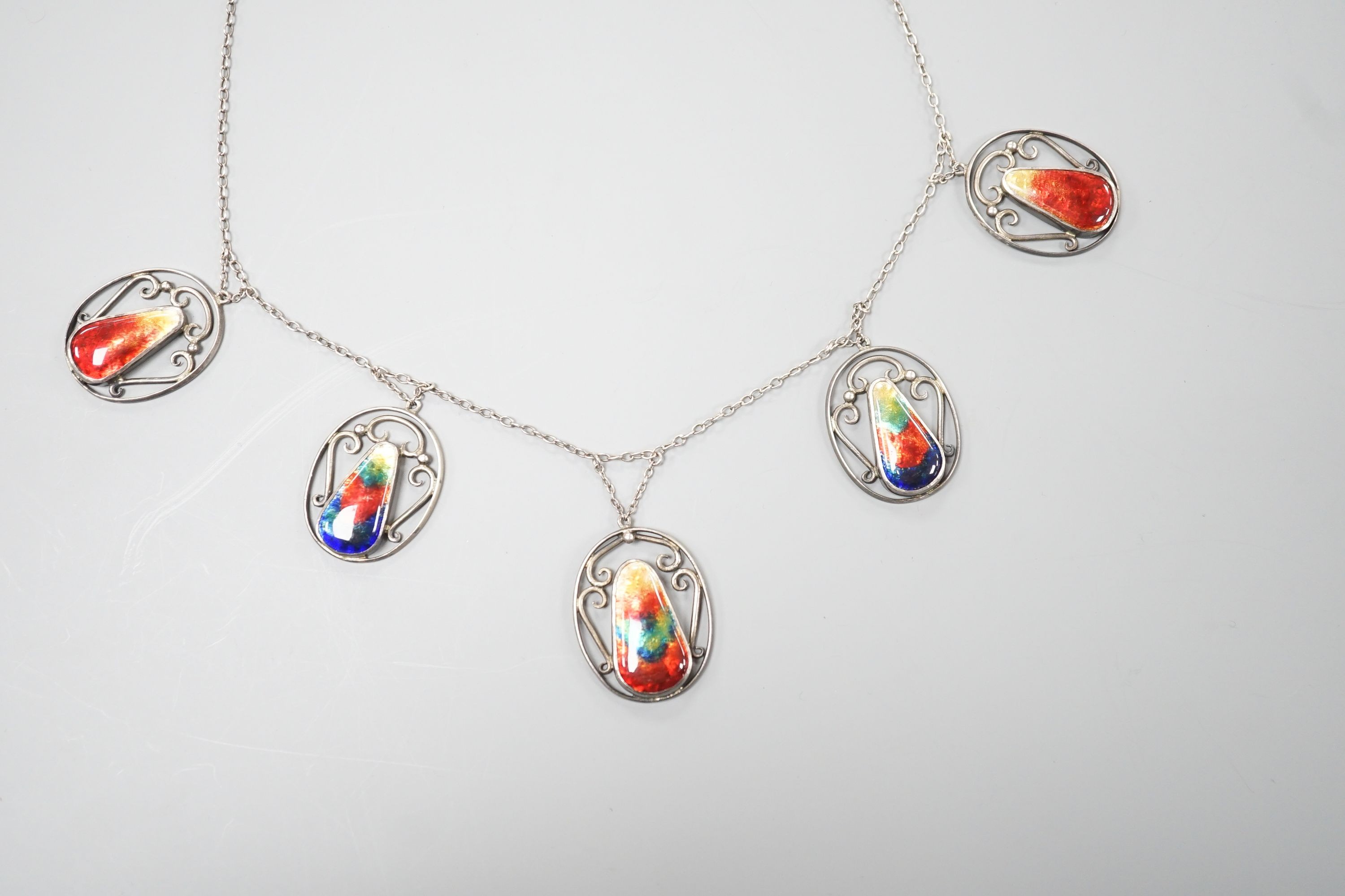 An Arts & Crafts white metal and six stone polychrome enamel set fringe necklace, 52cm.